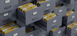 wall of filing cabinet drawers opened with yellow files