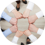 people with outstretched closed hands held in a circle