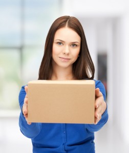 Woman with outstretched arms holding cardboard box