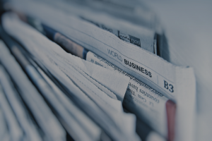 cross section of stack of newspapers with section heading 'world business'