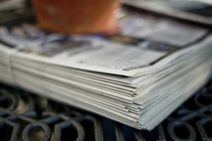 stack of newspapers on outdoor table