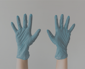 pair of hands with blue medical gloves